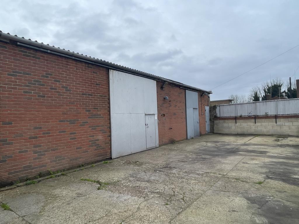 Lot: 48 - VALUABLE WORKSHOPS WITH OFFICES AND YARD AREA CLOSE TO TOWN CENTRE - View of workshops and enclosed side yard
